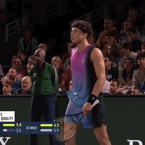 A Tennis Player Wipes His Nose With A Towel While Holding A Racquet GIF