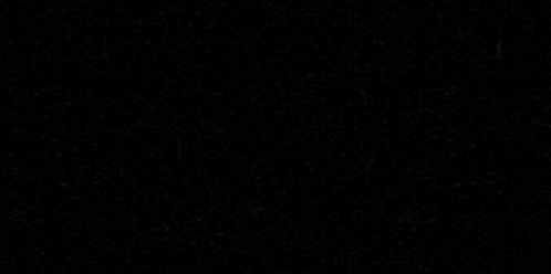 A Tesla Model 3 Is Parked In A Dark Room GIF