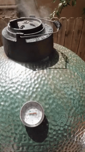 A Thermometer Sits On A Table Next To A Large Green Object GIF