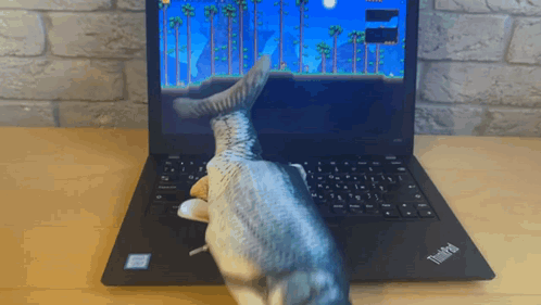 A Thinkpad Laptop With A Fish Toy On It GIF