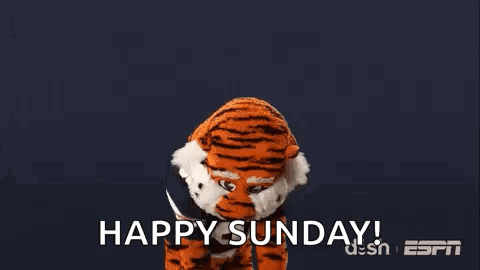 A Tiger Mascot Is Standing In Front Of A Blue Background With The Words `` Happy Sunday '' . GIF