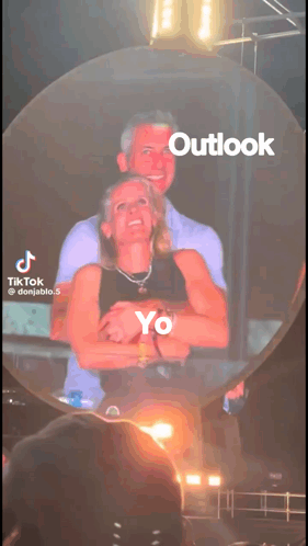 A Tiktok Video Of A Man And Woman Hugging With Outlook Written On The Bottom GIF