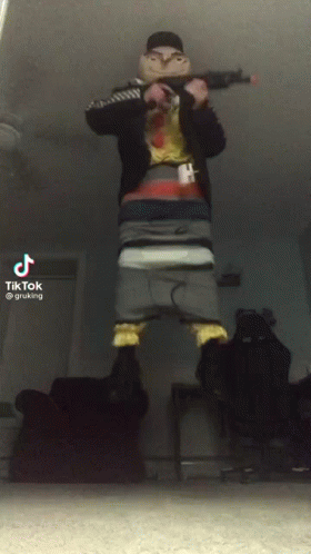 A Tiktok Video Of A Man Holding A Gun In His Hand GIF