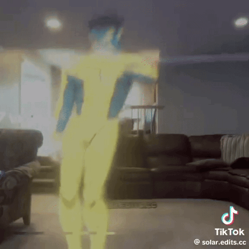 A Tiktok Video Of A Person Dancing In A Living Room With A Couch In The Background GIF