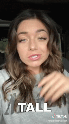A Tiktok Video Of A Woman With The Word Tall On It GIF