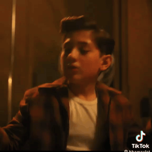 A Tiktok Video Of A Young Boy With A White Shirt GIF