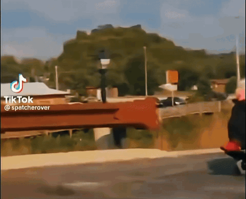 A Tiktok Video Shows A Person Riding A Bike On A Bridge GIF