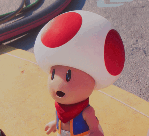 a toad with a red circle on his head and a scarf around his neck