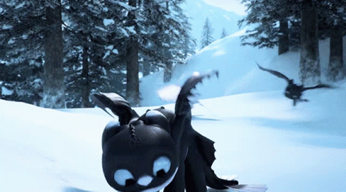 A Toothless Dragon Is Laying In The Snow With A Bird Flying In The Background GIF