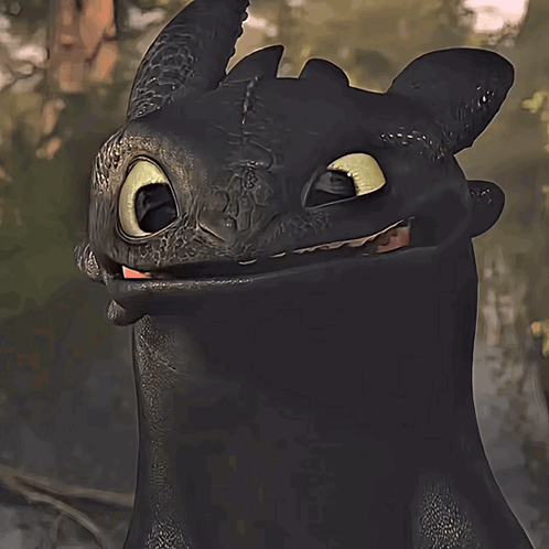 A Toothless From How To Train Your Dragon Is Smiling And Looking At The Camera GIF