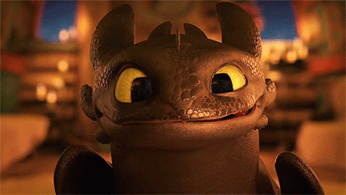 A Toothless From How To Train Your Dragon Is Smiling For The Camera GIF