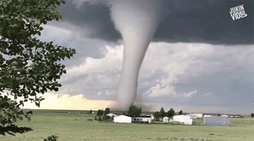 A Tornado Is Moving Through A Grassy Field With A Jukin Vine Logo In The Foreground GIF