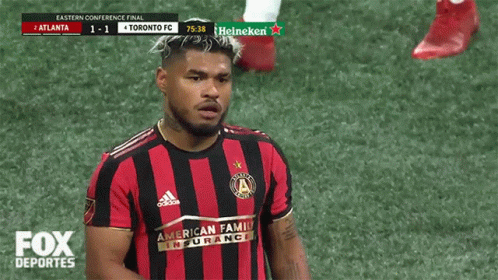 a toronto fc soccer player stands on the field
