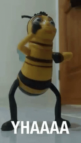 A Toy Bee Says Yhaaaa In White Letters On A White Surface GIF