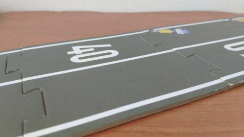 A Toy Car Is Driving On A Road With The Number 40 On It GIF