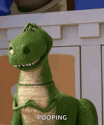 A Toy Dinosaur From Toy Story Is Pooping In Front Of A Cabinet GIF