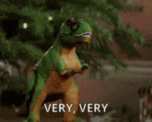 Toy Dinosaur In Front Of Christmas Tree Says Very Very GIF