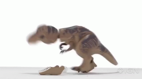 A Toy Dinosaur Is Walking On A White Surface With Its Mouth Open . GIF