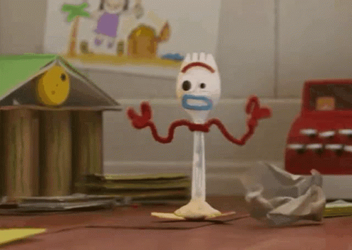 A Toy From The Movie Toy Story 4 Is Standing On A Wooden Floor . GIF