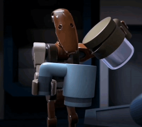 A Toy Robot Is Holding A Cup Of Coffee In Its Hand GIF