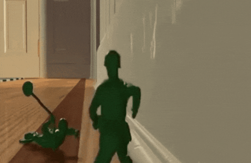 A Toy Soldier Laying On The Floor With A Hammer GIF