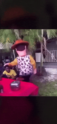A Toy Story Character Is Standing On A Table GIF