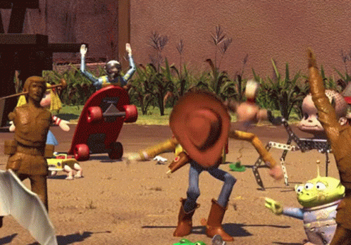 A Toy Story Scene With Woody And Aliens In The Sand GIF