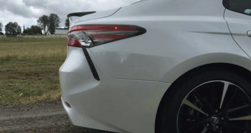 A Toyota Car Is Parked On A Dirt Road GIF
