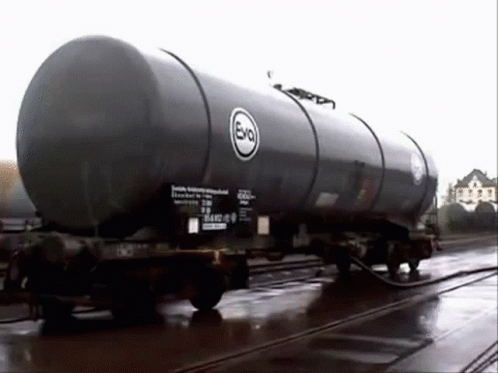 A Train Car With A Large Tank On The Side Of It Is Being Filled With Liquid . GIF