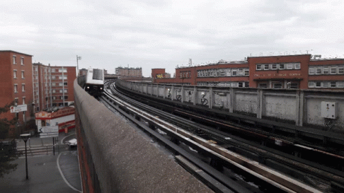 Train Passing Building With Robert Sign GIF