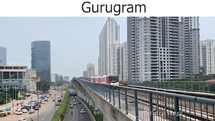 A Train Is Going Down A Bridge In A City With A Lot Of Buildings In The Background . GIF