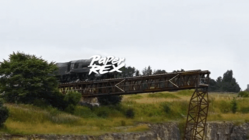 A Train Is Going Over A Bridge With The Words Paper Rex Written On The Bottom GIF