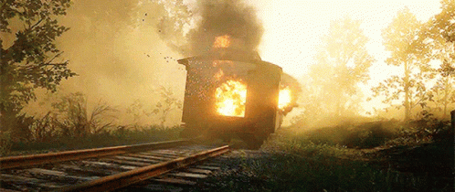 A Train Is On Fire On The Tracks With Smoke Coming Out Of It GIF