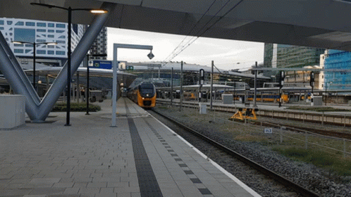 A Train Is Pulling Into A Station With A Sign That Says ' Ns ' On It GIF