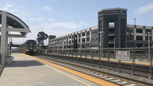a train station with a sign that says " caution " on it
