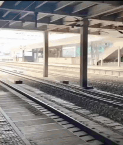 A Train Track Going Under A Bridge With A Sign That Says ' A ' On It GIF
