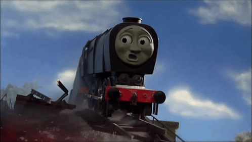A Train With A Surprised Look On Its Face Is Going Down The Tracks GIF
