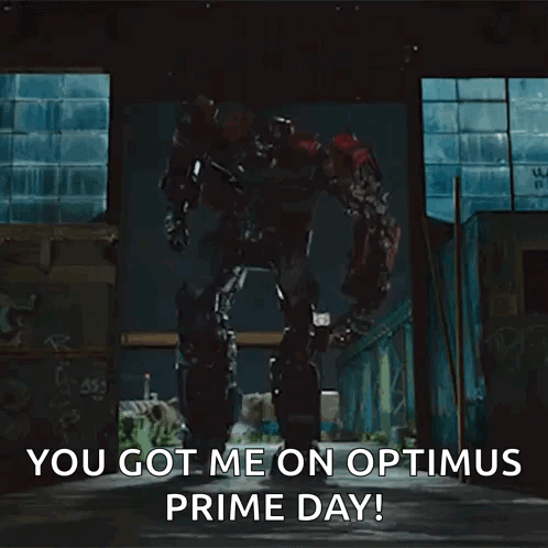 A Transformer Robot Is Standing In A Dark Room And Says `` You Got Me On Optimus Prime Day ! '' GIF