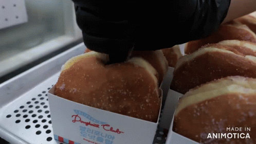 A Tray Of Doughnuts With A Label That Says Made In Animotica GIF