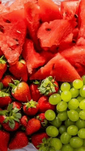 A Tray Of Watermelon , Strawberries , And Grapes . GIF