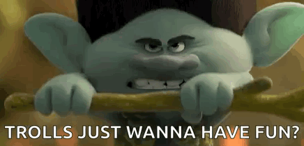 A Troll From The Movie Trolls Just Wanna Have Fun Is Holding A Stick In His Hands . GIF