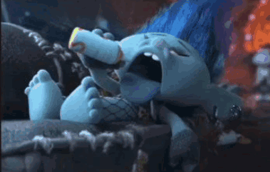 A Troll Is Drinking Milk From A Bottle While Laying Down . GIF