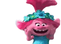 a troll wearing a blue dress and a flower crown is smiling .