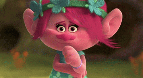 A Troll With Pink Hair And A Flower Crown On Her Head Is Making A Funny Face . GIF