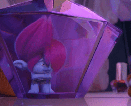 A Troll With Pink Hair Is Inside Of A Purple Container GIF