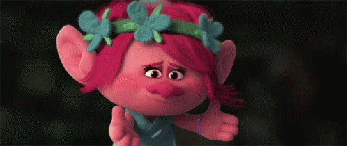 A Troll With Red Hair And Blue Flowers On Her Head Giving A Thumbs Up GIF