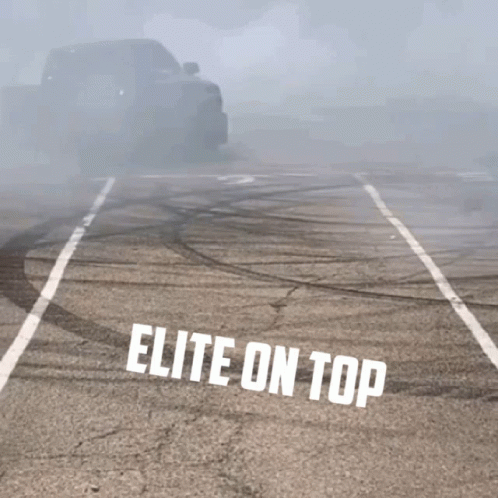 A Truck Is Drifting In A Parking Lot With The Words Elite On Top GIF