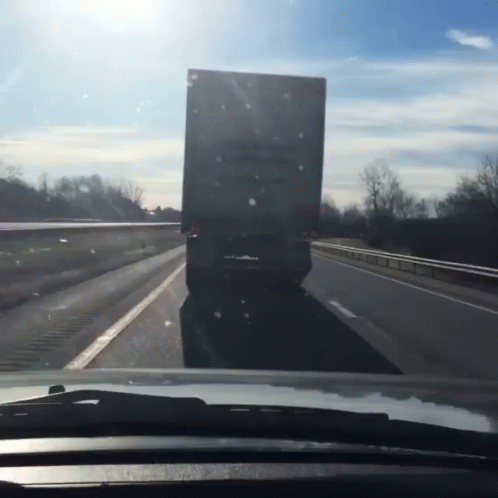 A Truck Is Driving Down A Highway With A Sign On The Back That Says ' A ' On It GIF