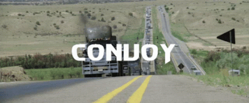 A Truck Is Driving Down A Highway With The Word Conuoy Written On It GIF