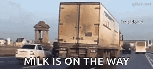 A Truck Is Driving Down A Highway With The Words Milk Is On The Way Written On The Bottom GIF